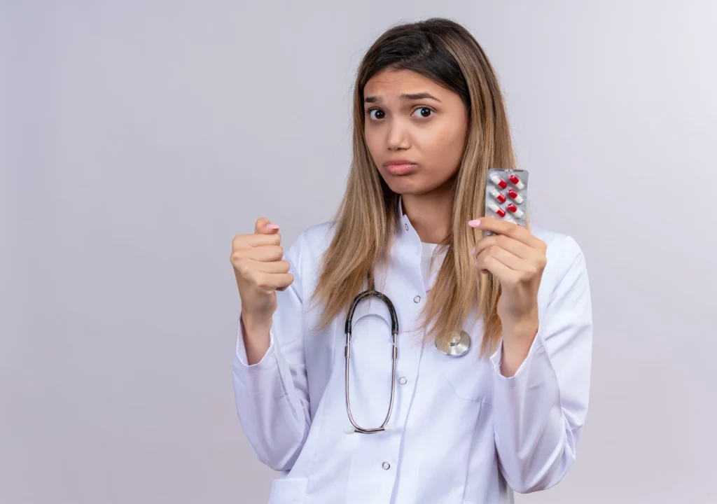 Doctor holding a blister pack of medication while discussing generic tofacitinib and Xeljanz